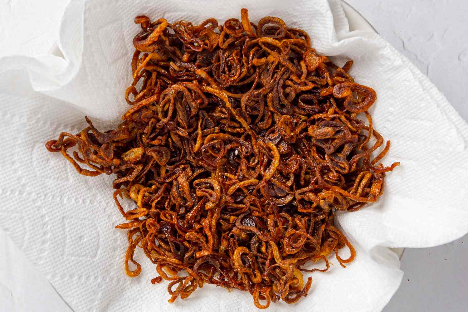 Crispy Shallots Cooling on a Paper Towel Lined Plate