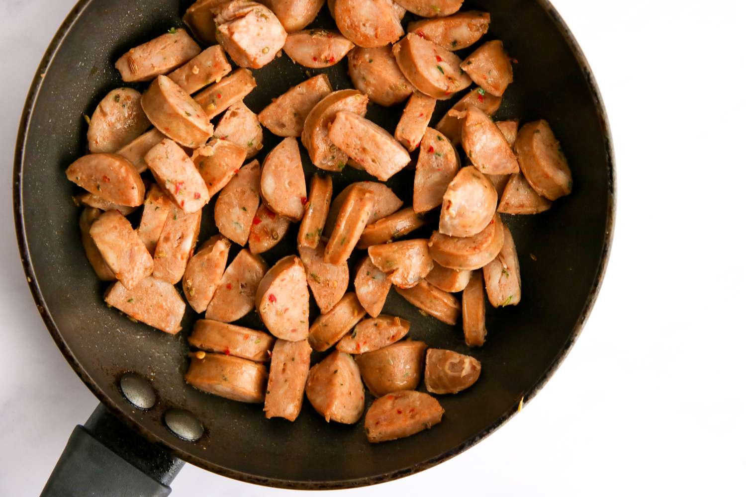 Sausage cooked in skillet.