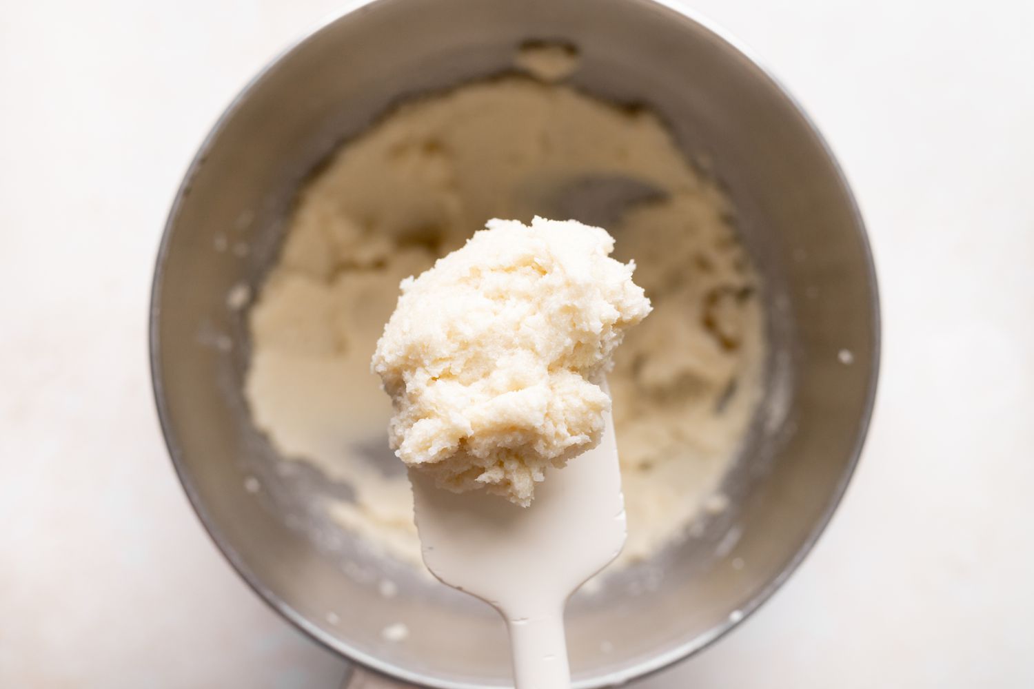 Making the batter for butter cake with fresh cherries .