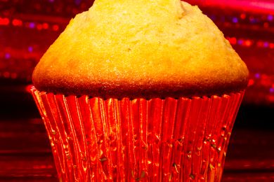 Mantecadas in Red Shiny Cupcake Liner, Surrounded by a Sparkly Red Background