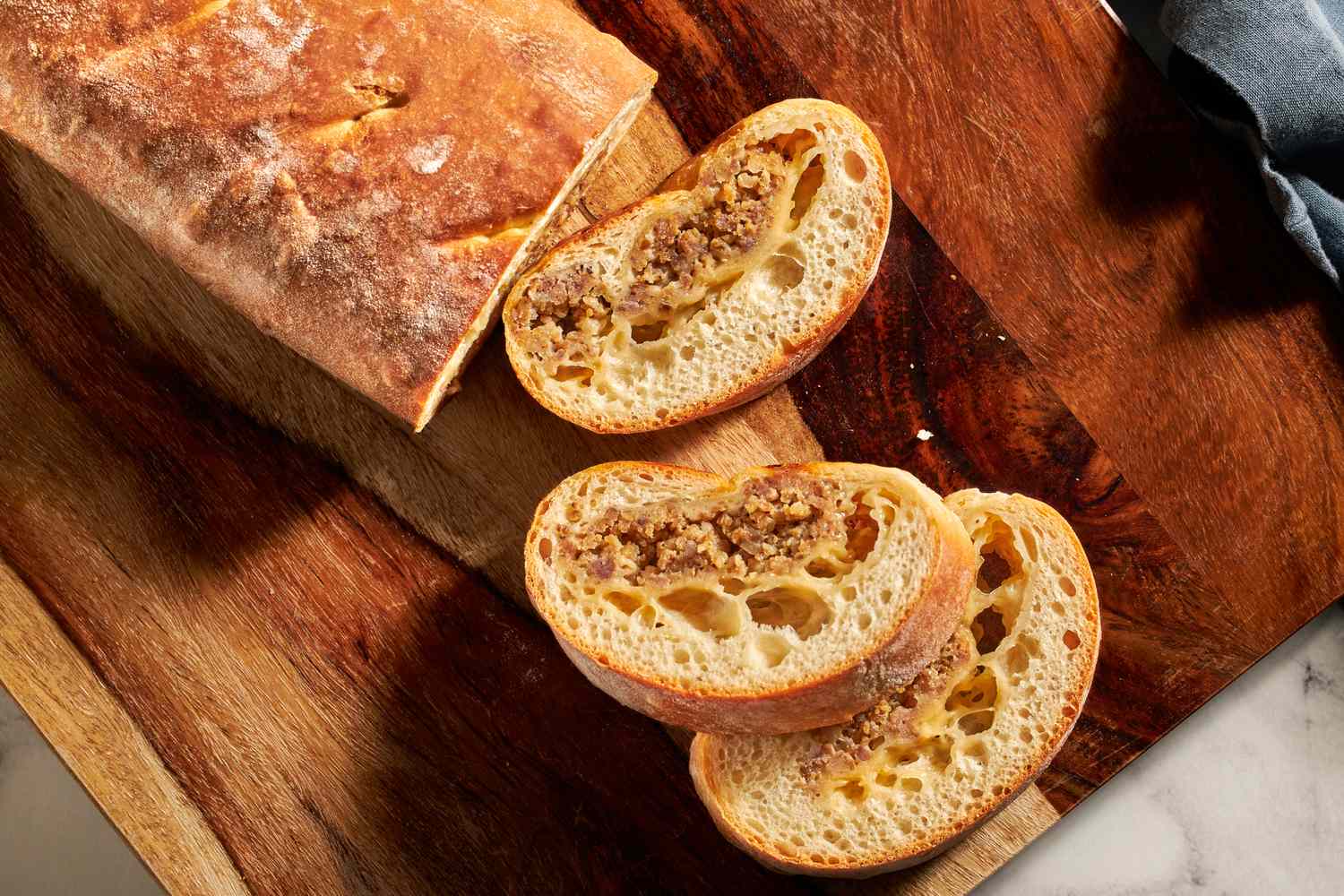 Sliced loaf of bread with a sausage filling