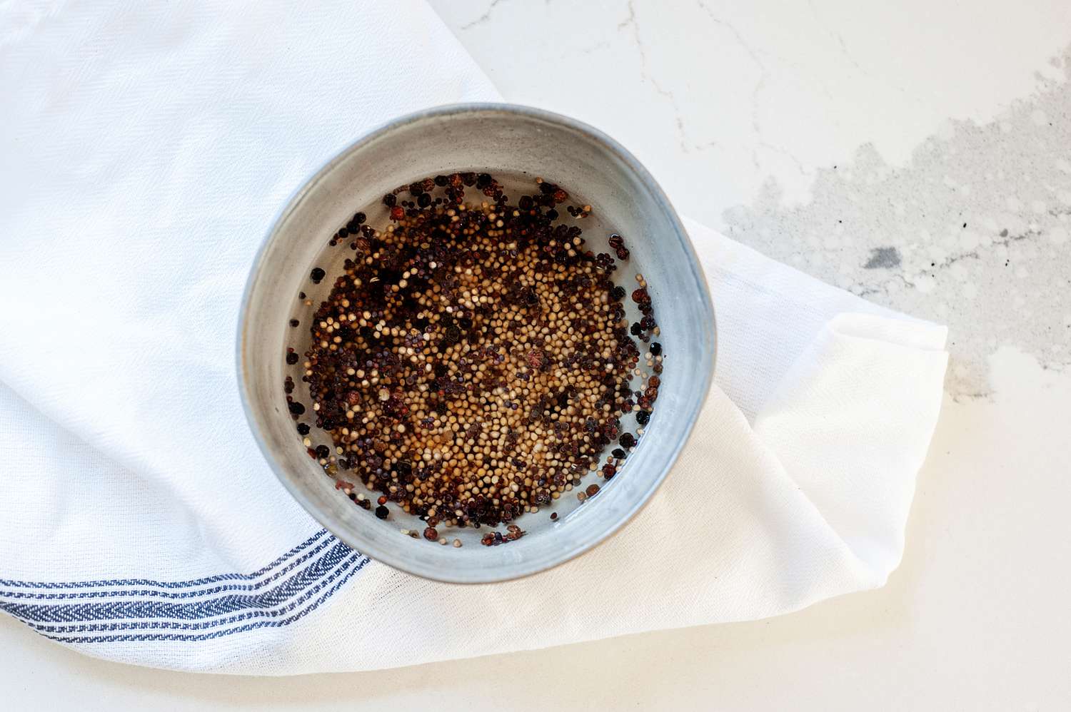 Mustard seeds in a small bowl to make a honey mustard recipe