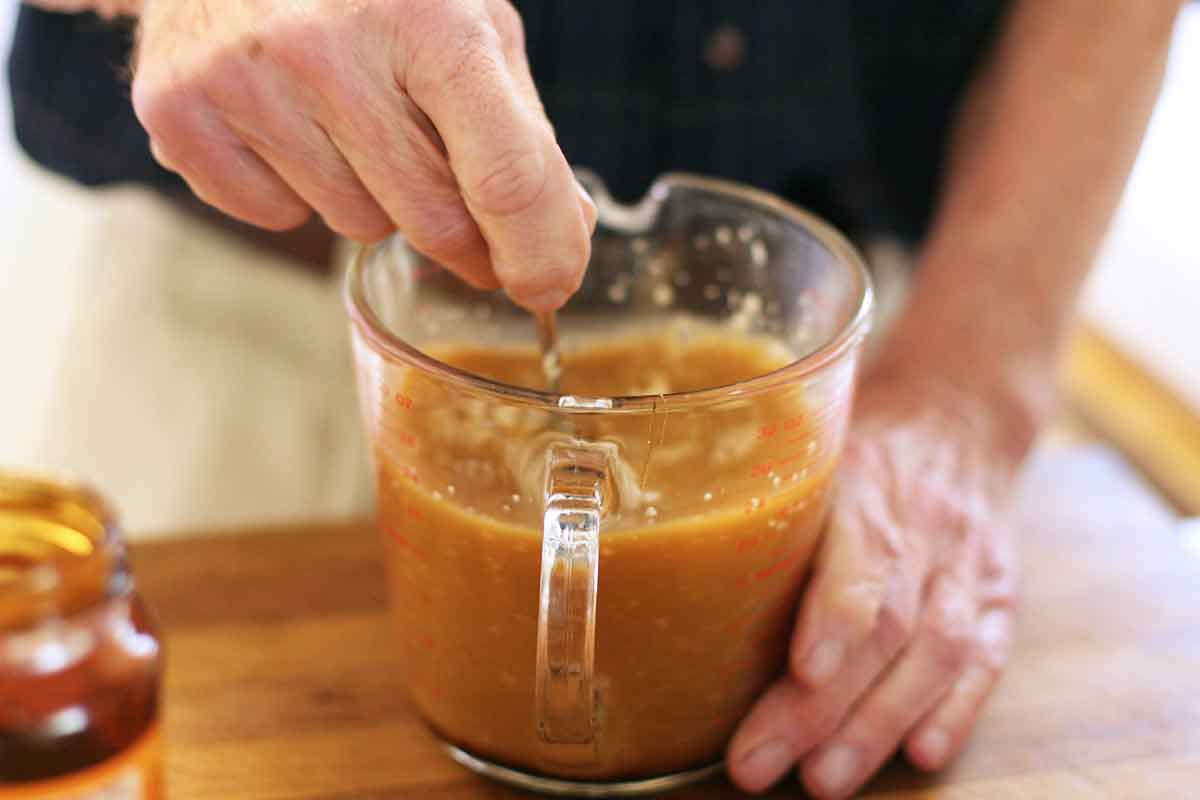 Dissolving yeast with water and molasses in a measuring cup