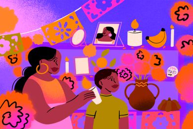 Dia de Muertos altar with a young boy and woman standing in front of it