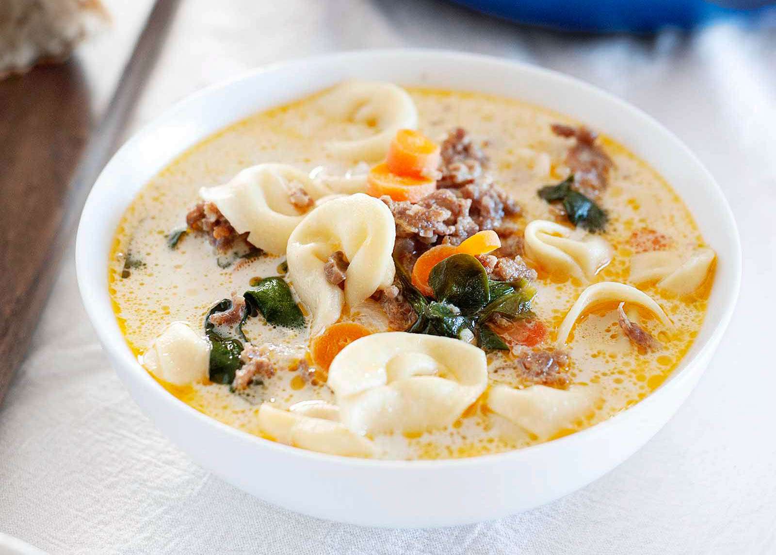 Tortellini and Sausage Soup in a white bowl