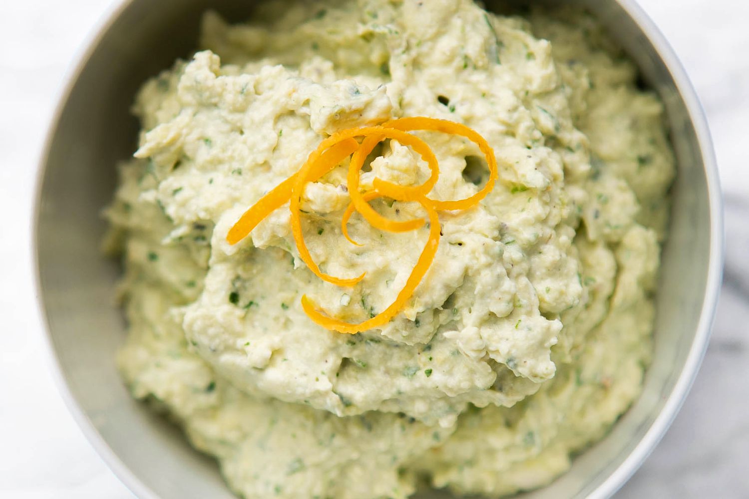 Bowl of Artichoke Lemon Dip Topped With Lemon Zest