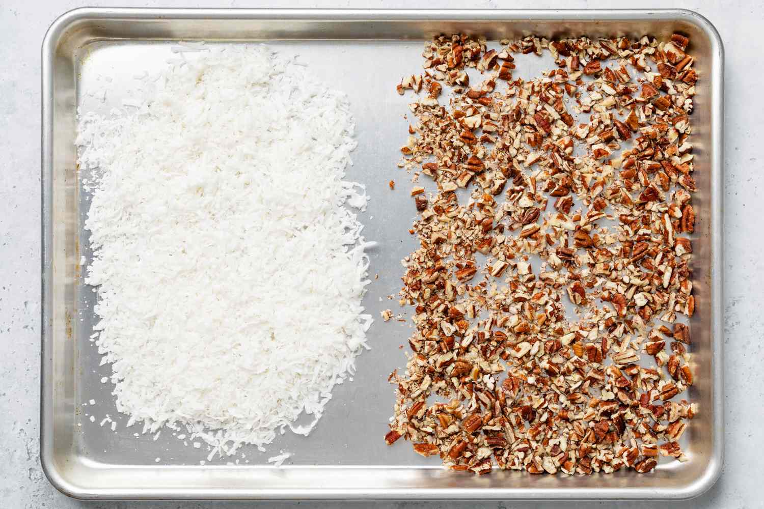 Sweetened Desiccated Coconut and Chopped Pecans on a Baking Sheet