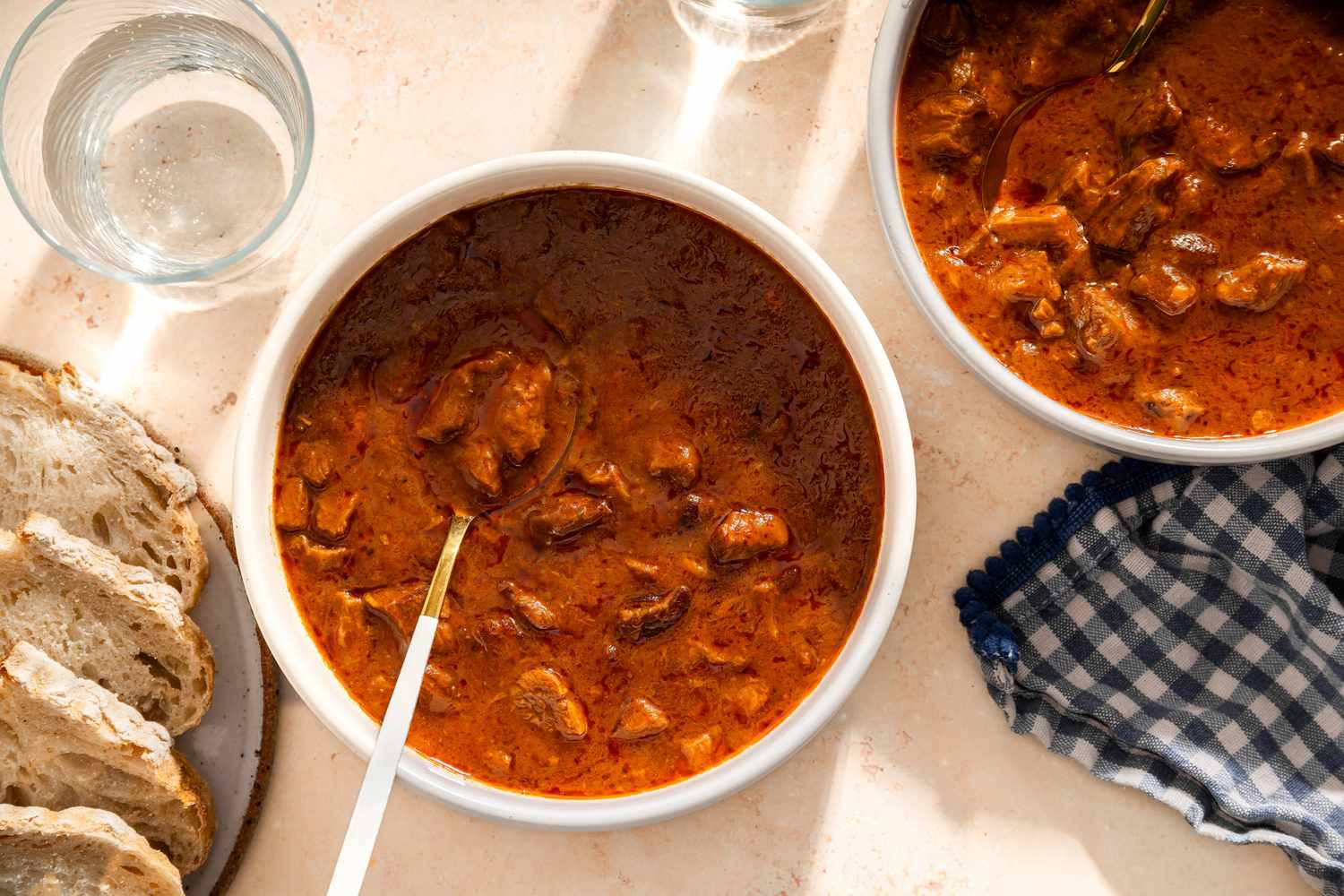 2 bowls of Grandma Helen’s Beefy Tomato Soup, sliced crusty bread on the side