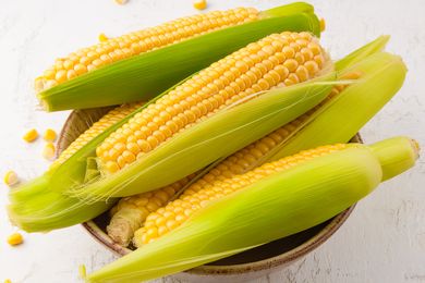 Overhead view of a bowl filled with sweet corn on the cob