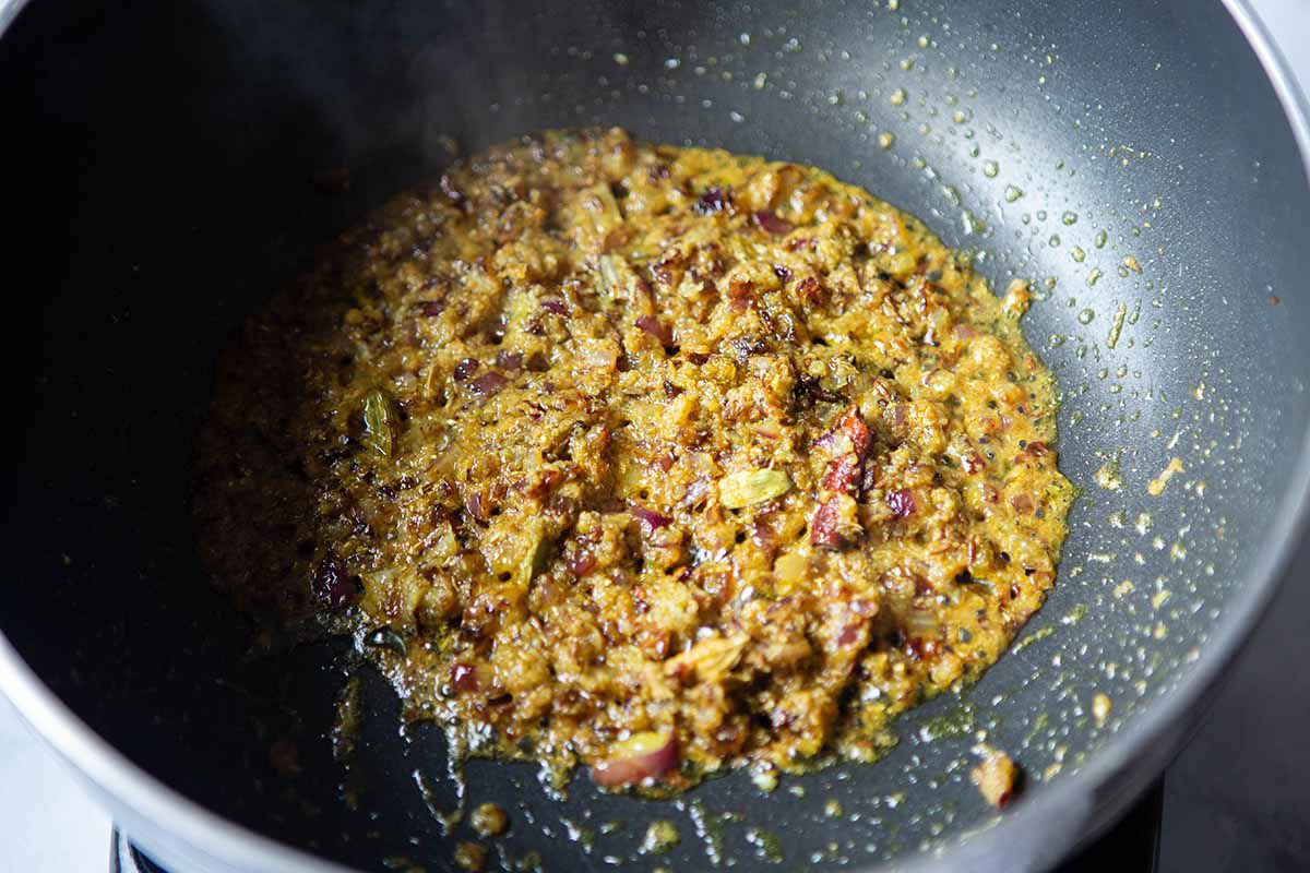 Vegan Chana Masala - onions, spices, in pan with oil