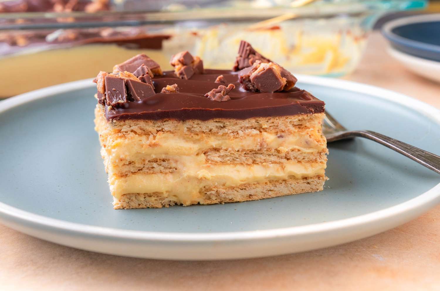 Peanut Butter Éclair Cake on a dessert plate with a fork