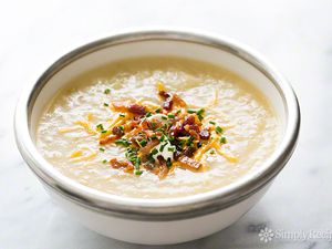 Baked Potato Soup in serving bowl with cheese, onions and bacon