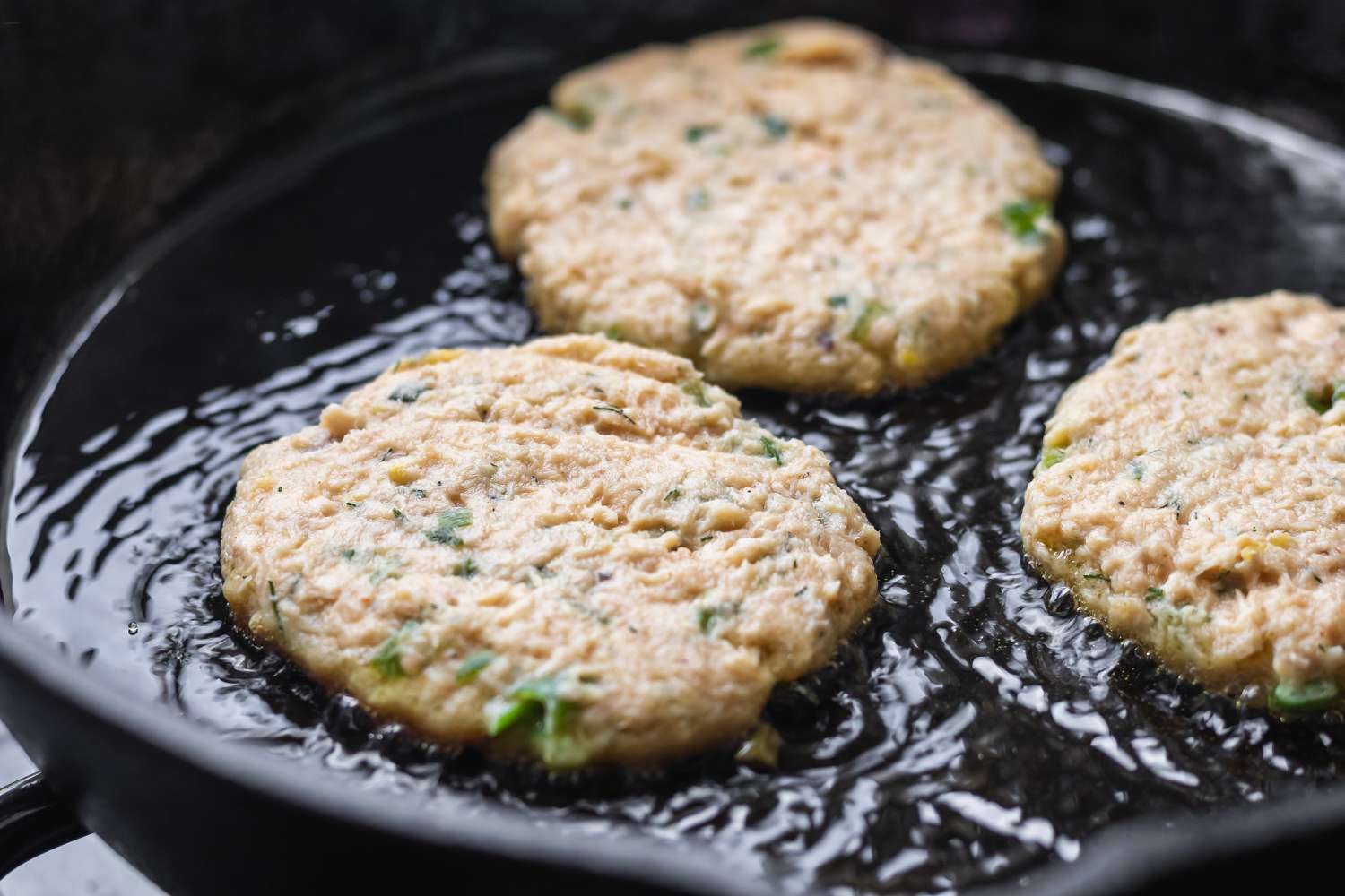 Canned salmon recipe being pan fried.