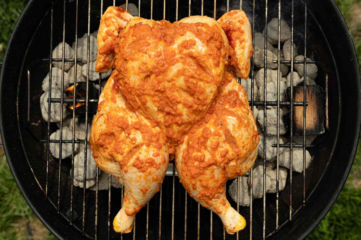 Spatchcocked Chicken on Grill for Smoked Spatchcock Chicken with Harissa Butter and Grilled Carrots