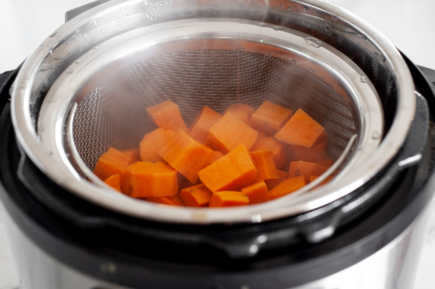 Steamed Sweet Potatoes in a Metal Steamer Basket