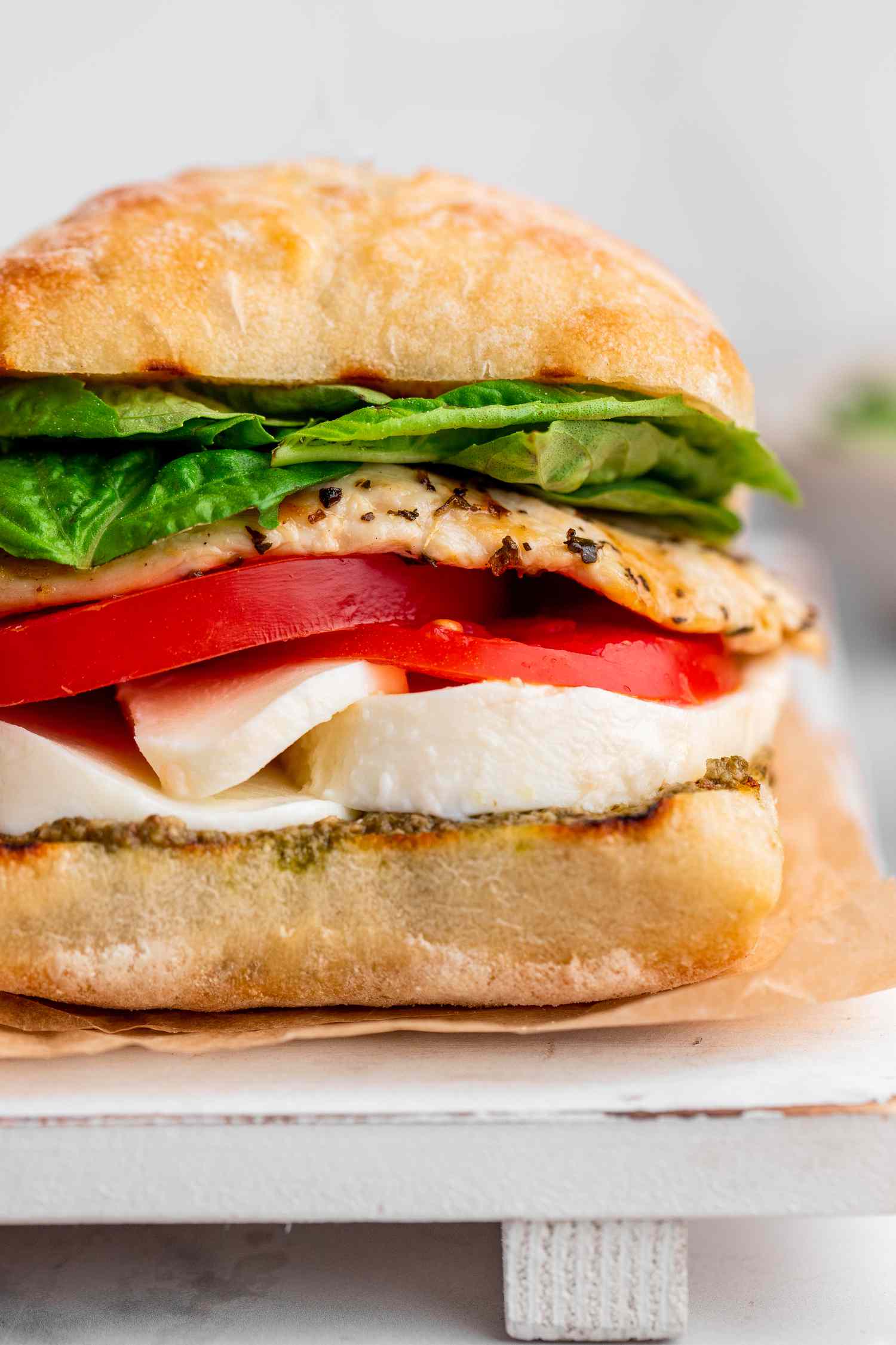 Grilled Chicken Caprese Sandwich on a Parchment Lined Tray