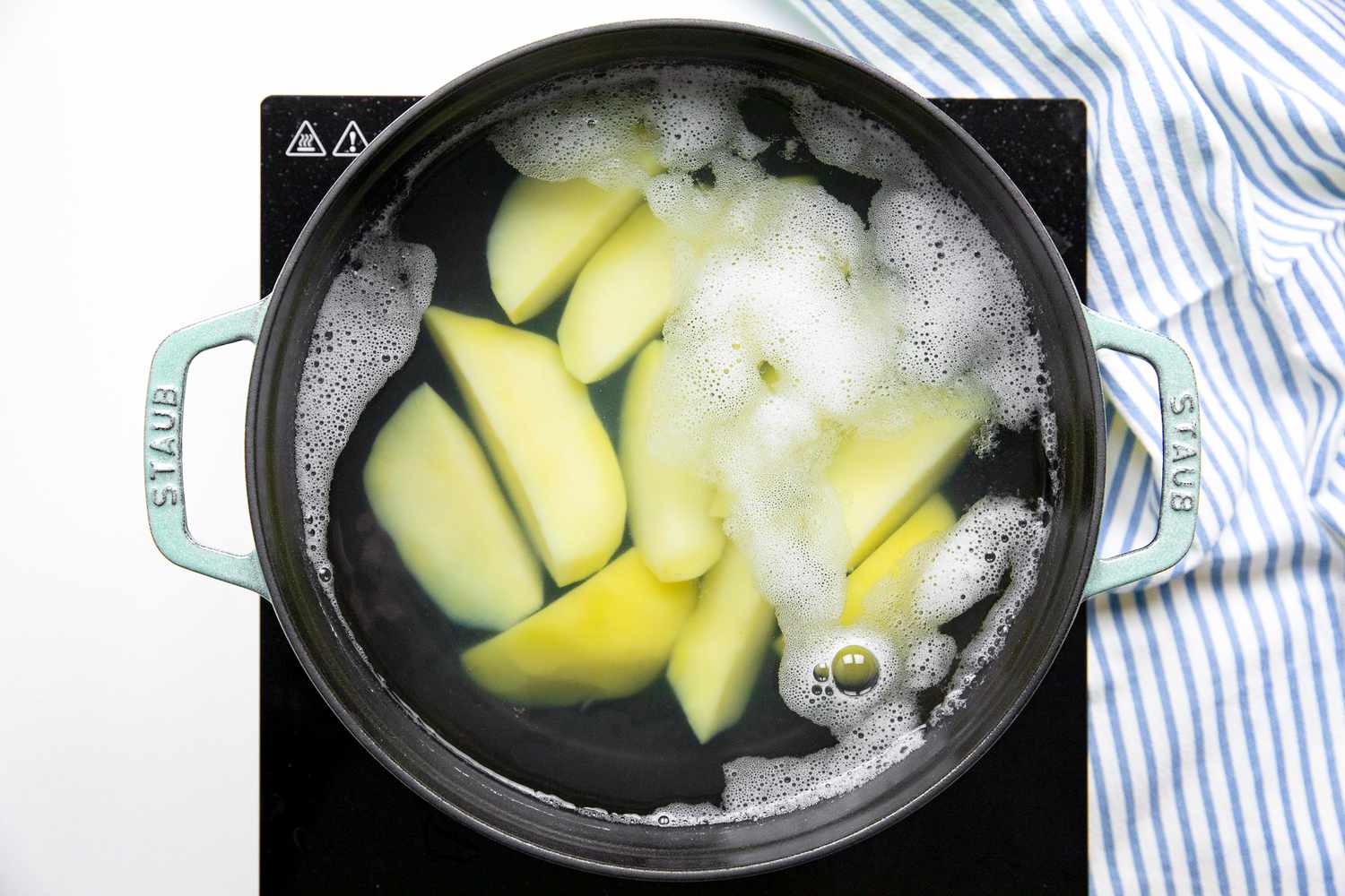 Peeled Yukon Gold Wedges Boiled in Dutch Oven Filled with Salted Water for Potato Croquettes Recipe