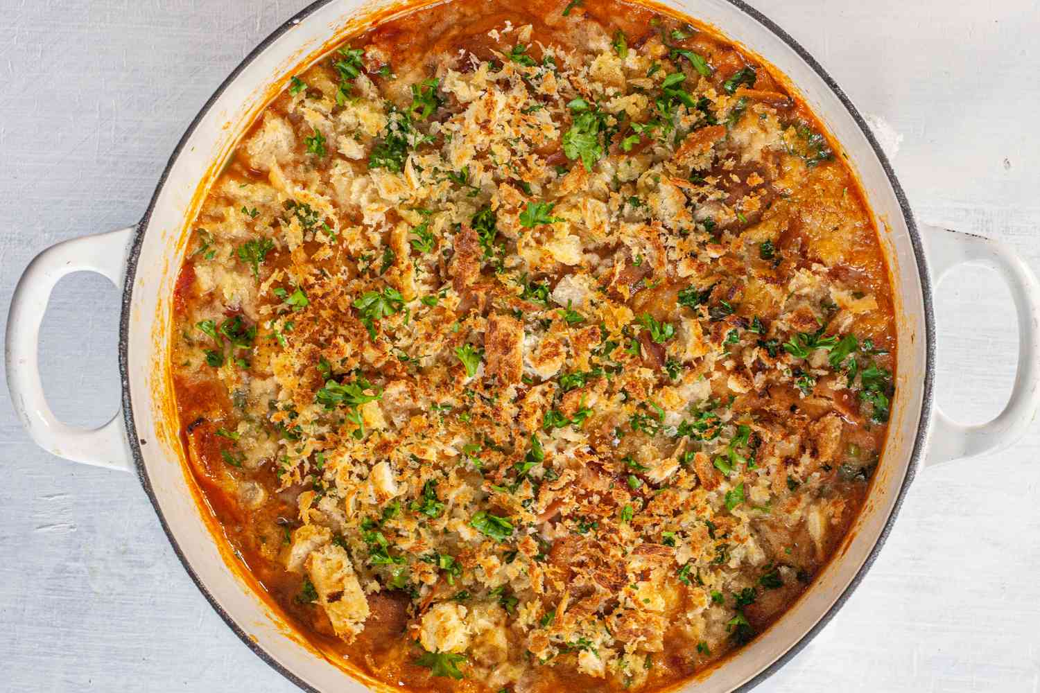 Broiled cassoulet in white Dutch oven.