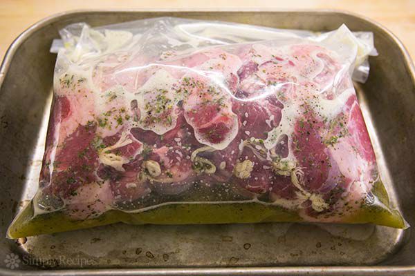 Roast leg of lamb marinating in plastic bag