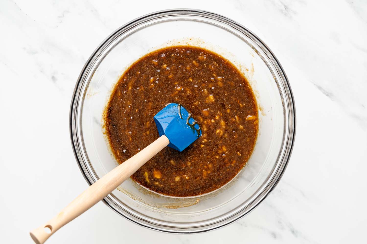Melted Coconut Oil Mixed Into Bowl With Mashed Bananas and Espresso Mixture