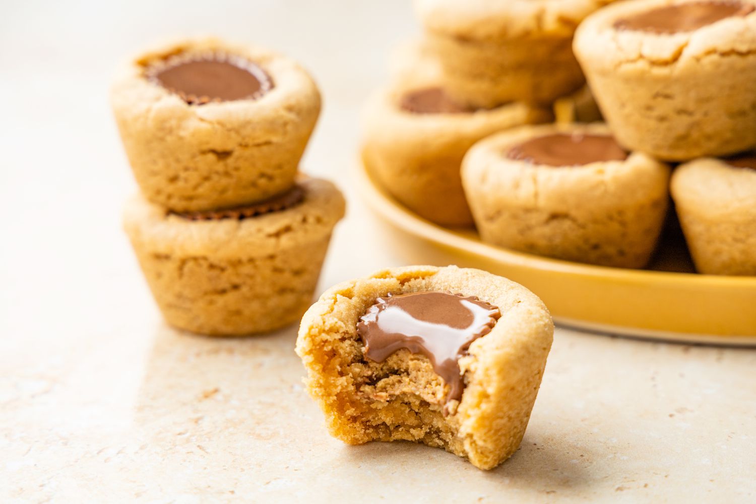 Peanut Butter Cup Cookie Bitten into with More Cookies in the Background