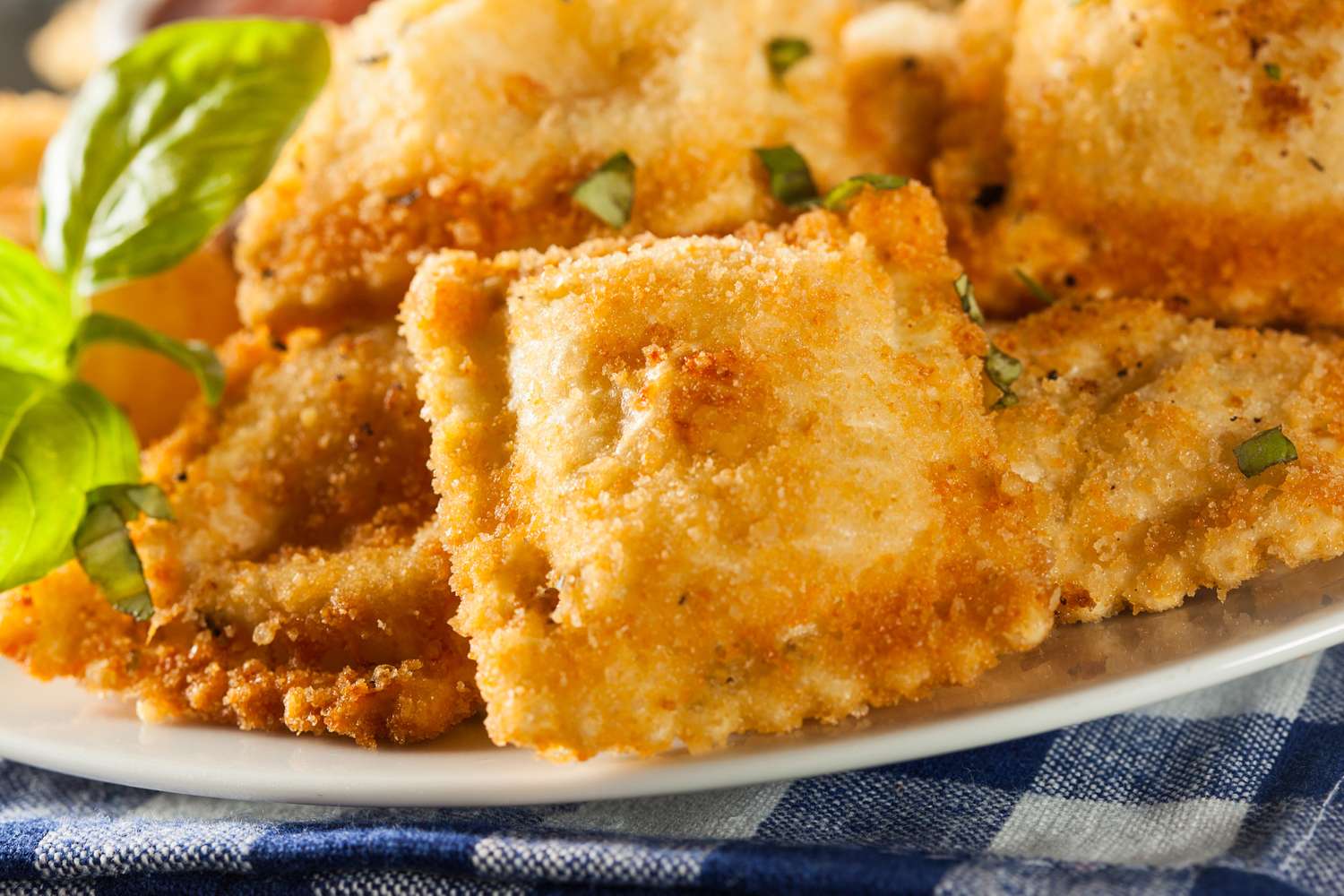 Plate of fried ravioli garnished with herbs