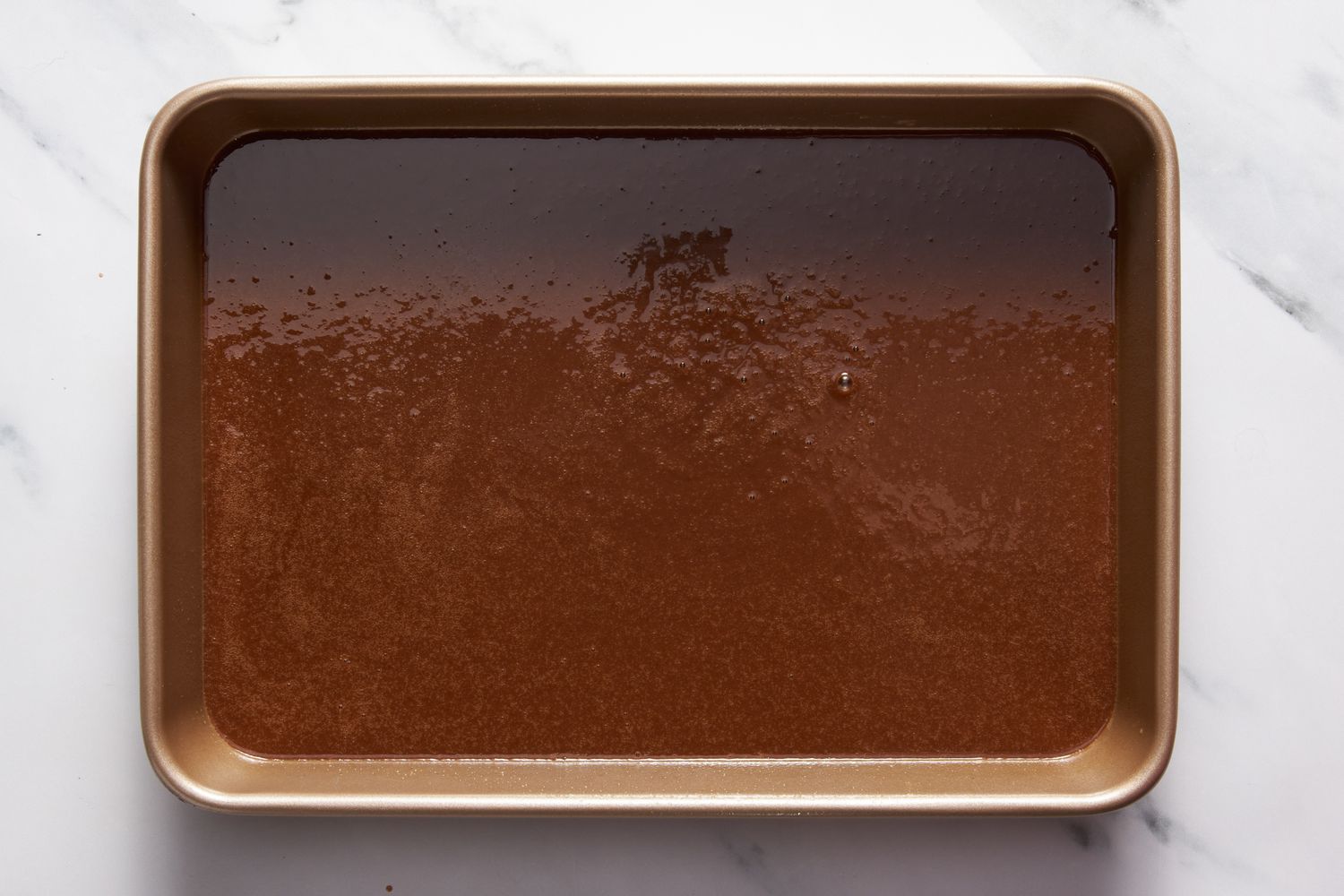 Dr. Pepper cake batter in a 9x13-inch baking pan