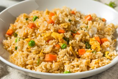Homemade Chinese Asian Fried Rice with Peas and Carrots in a bowl