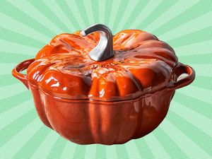 A pumpkinshaped ceramic container with a metal stem lid