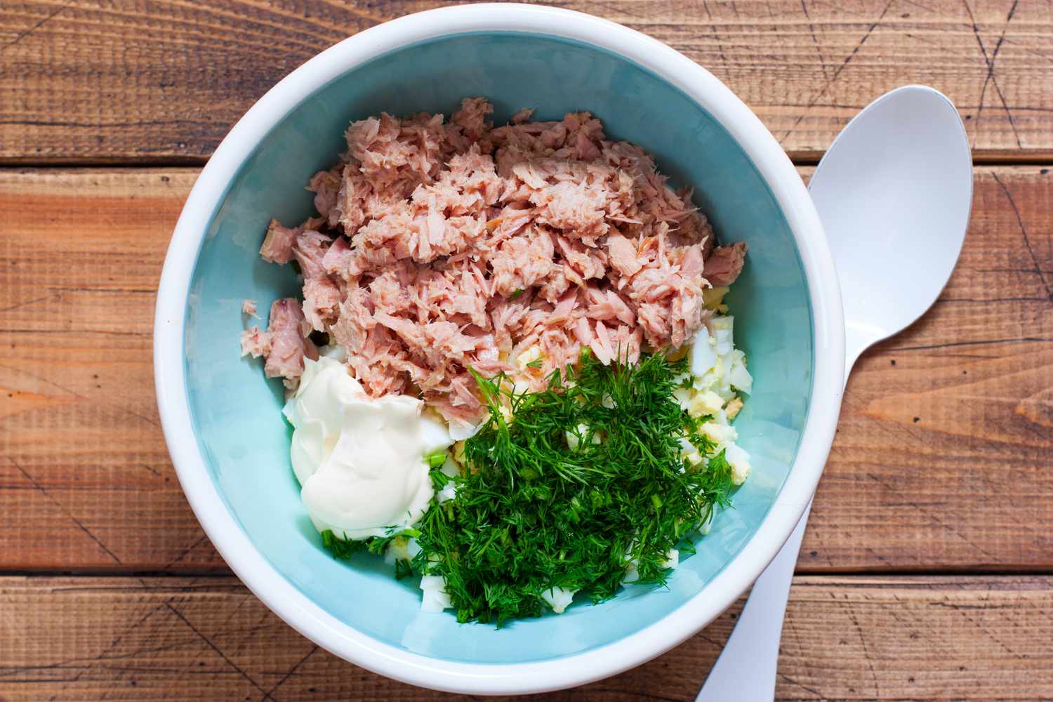 bowl of tuna with mayo, dill, and boiled eggs