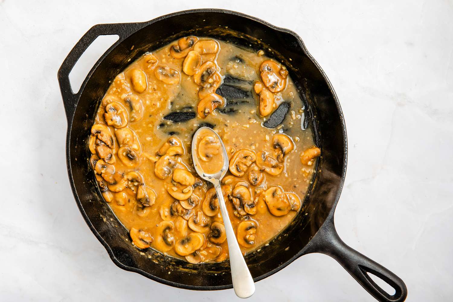 marsala chicken sauce in the cast iron skillet for chicken marsala recipe
