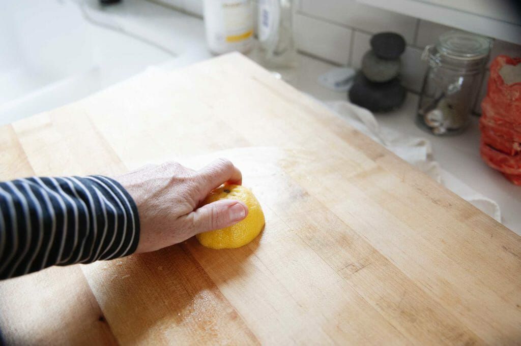 Clean wood cutting board with lemon