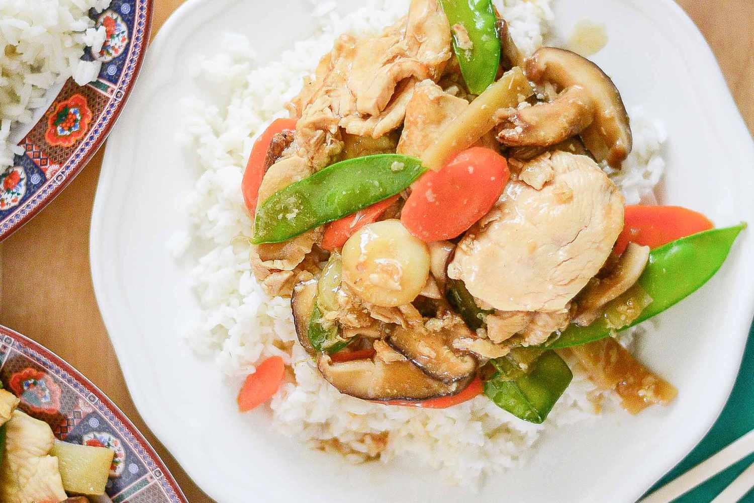 Moo Goo Gai Pan Chicken on a white plate with rice