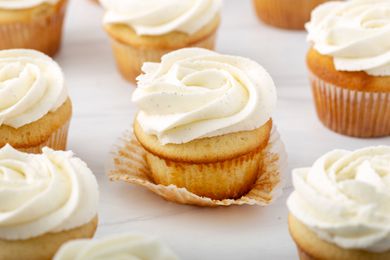 Close up of vanilla cupcakes with swirls of vanilla icing