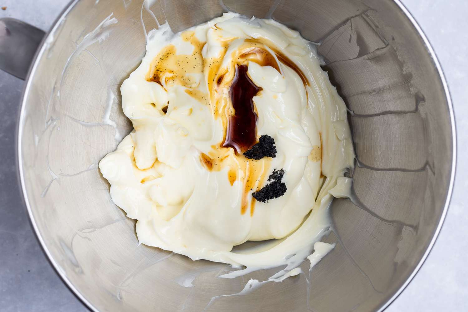 Vanilla added to the no bake cheesecake filling in a mixer bowl.