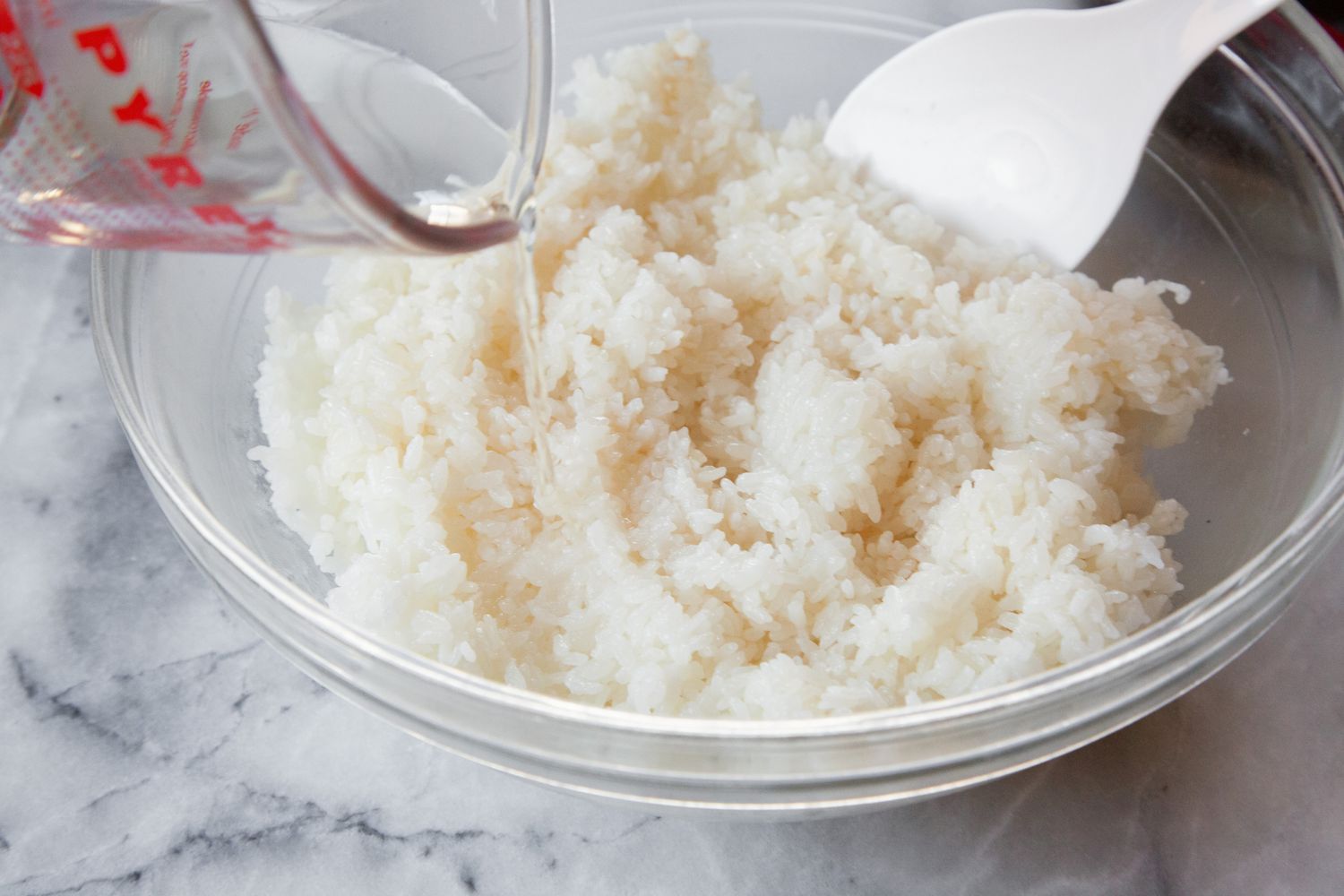 Vinegar Mixture Added to Sushi Rice