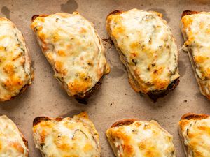 close up view of several Soupy Toasts on a parchment lined sheet pan