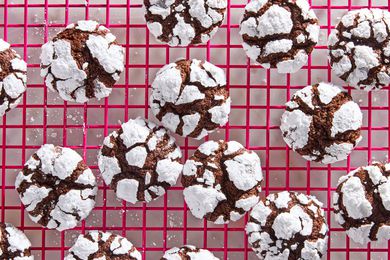 Chocolate crinkle cookies on a hot pink cooling rack