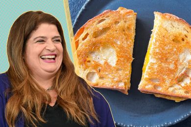 Alex Guarnaschelli with a grilled cheese sandwich on a plate next to her