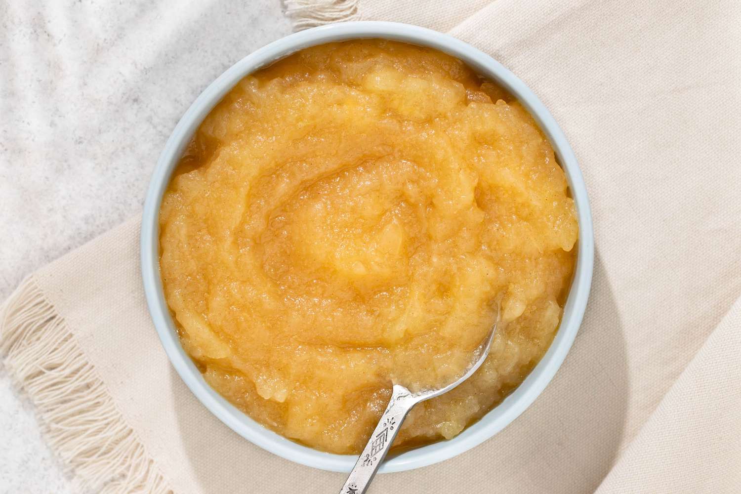 Microwave Applesauce in a bowl with a spoon