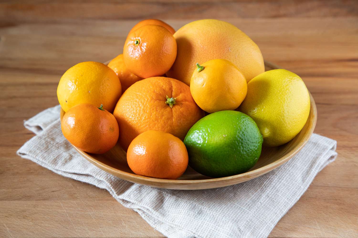 Citrus in a bowl on a wooden countertop