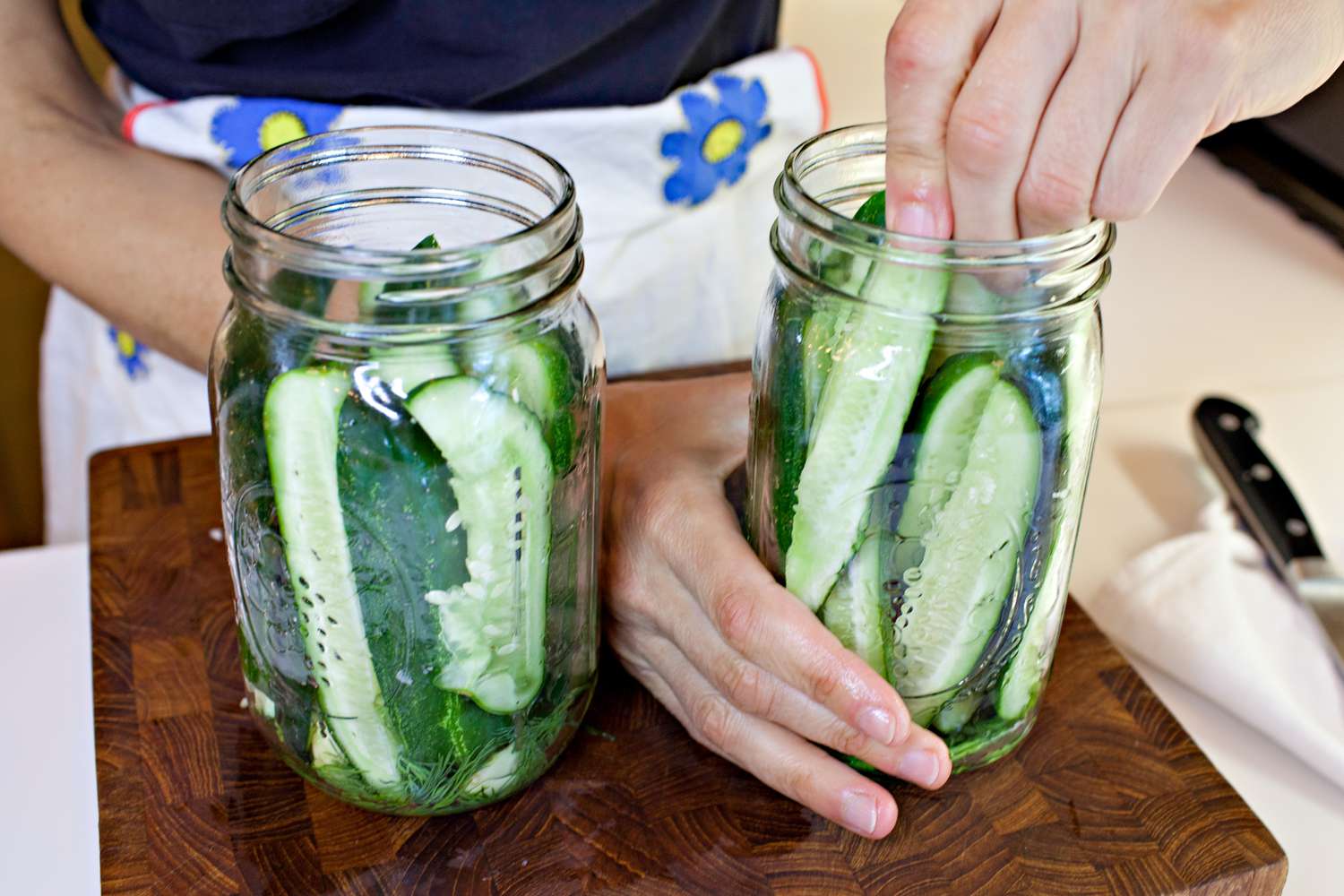 Cucumber Wedges Stuffed into Mason Jars for Fermented Pickles