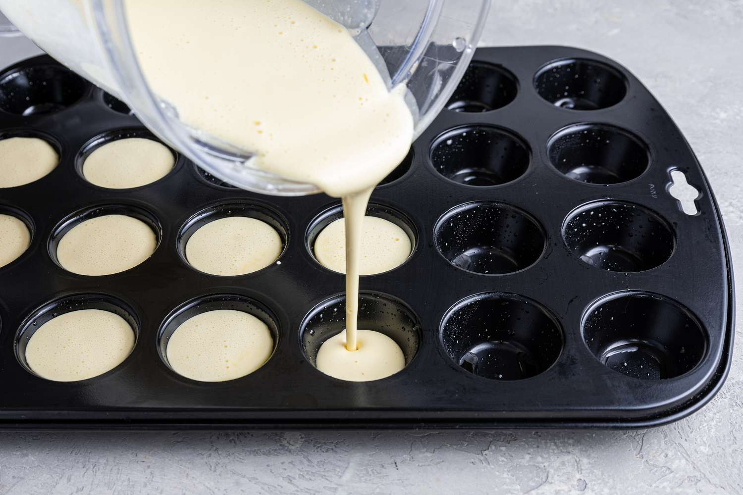 Brazilian Cheese Bread Recipe Batter Poured into a Muffin Tin