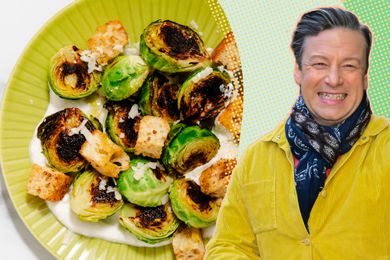 Jamie Oliver wearing a yellow corduroy jacket next to a plate of charred Brussels sprouts on a bed of yogurt
