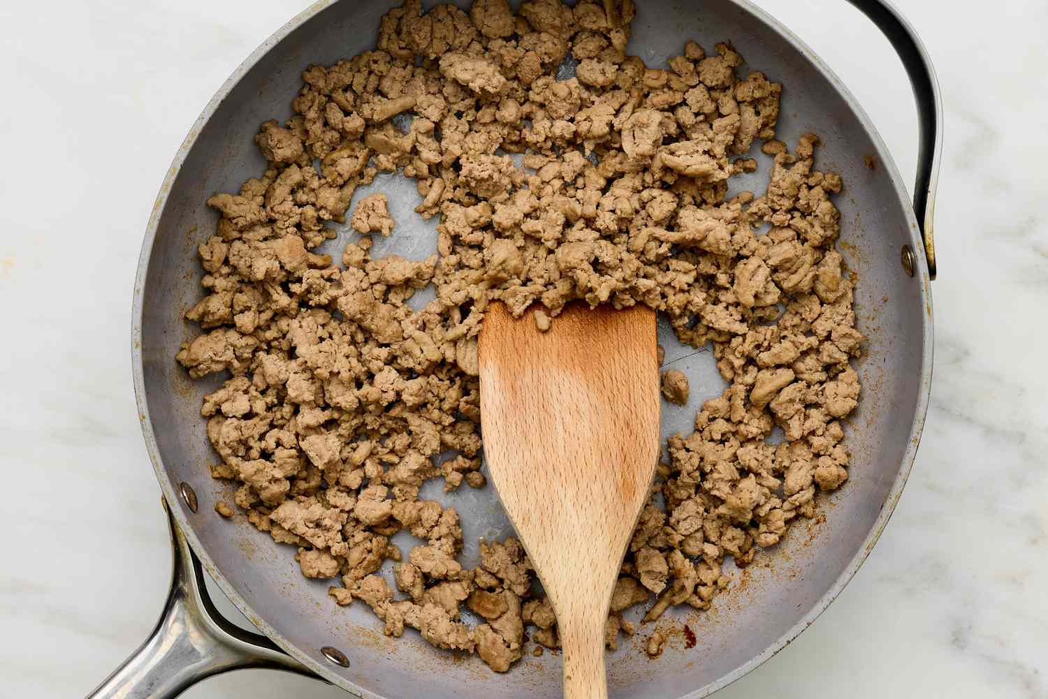 Cooked ground turkey in a skillet for 5-ingredient turkey taco bowl recipe