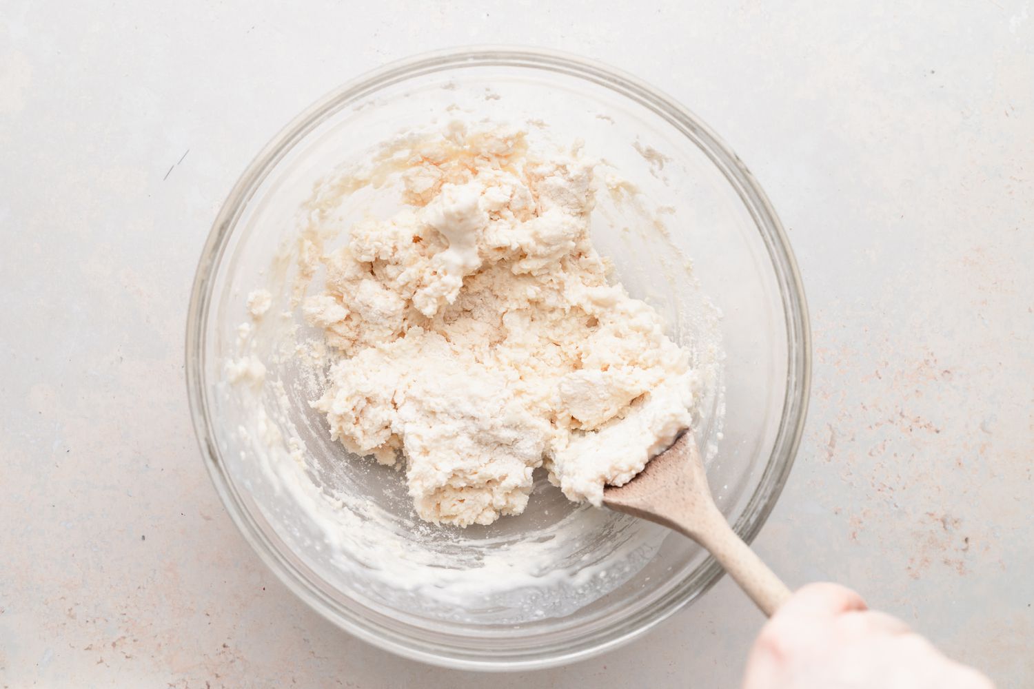 Making biscuits in a glass bowl for a biscuits and gravy recipe.