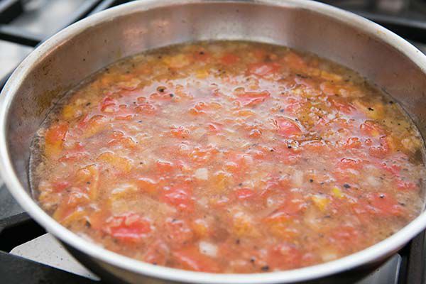 Cooking the tomato broth base for authentic sopa seca de fideo