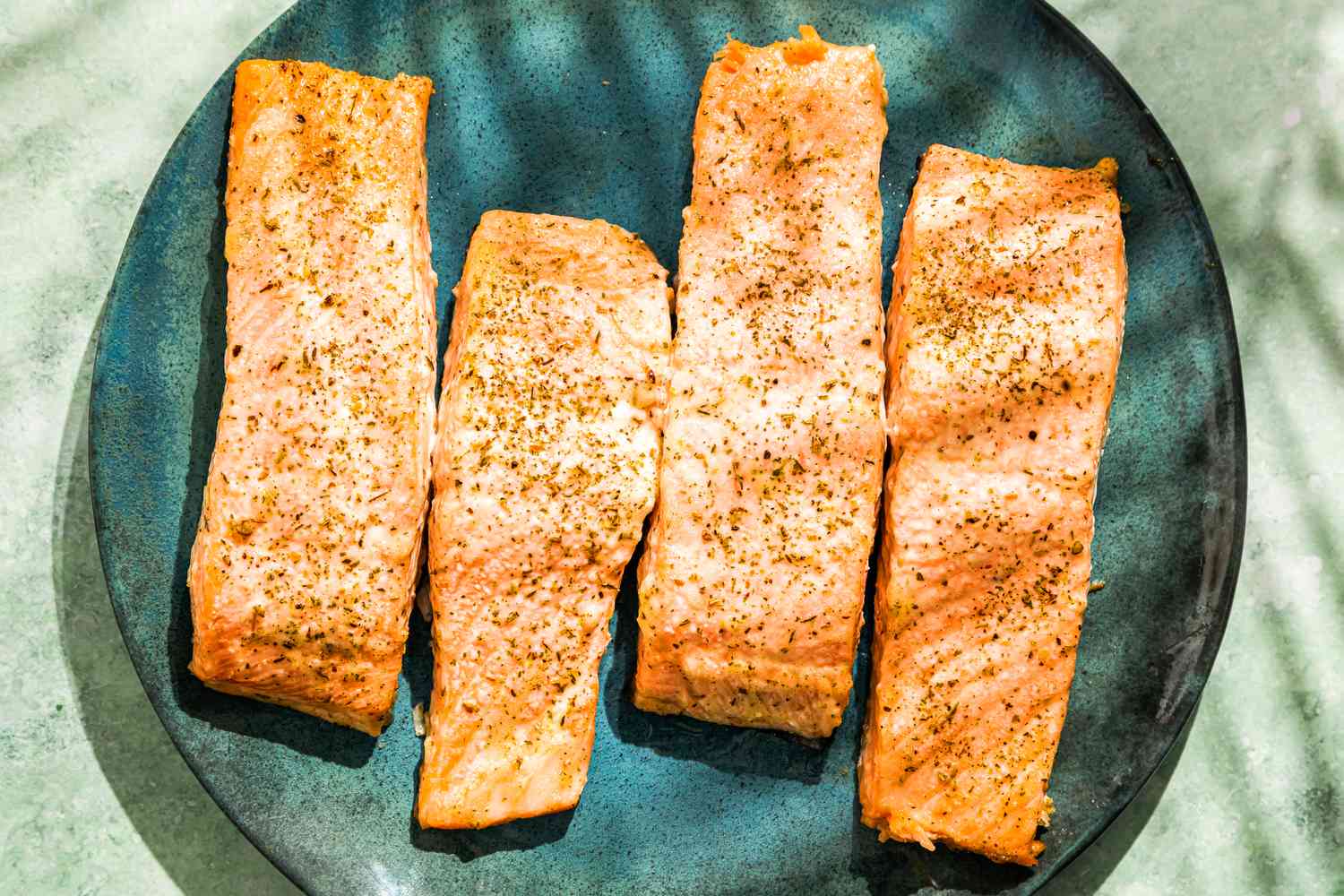 Four mayo salmon fillets on a plate