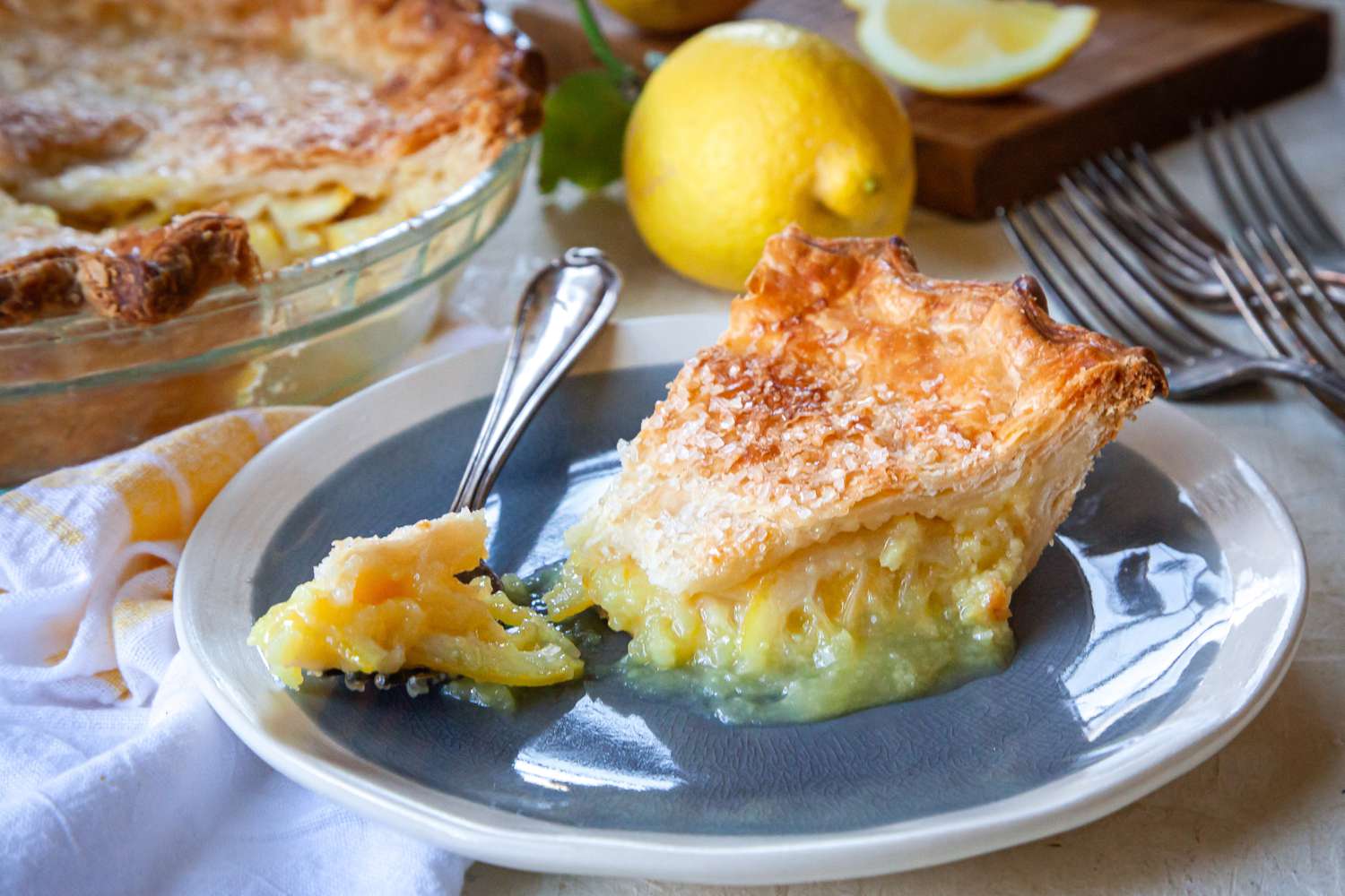 A slice of Ohio Lemon Pie with a forkful on a plate.