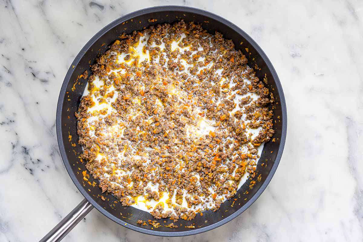 Seasoning and milk ground beef to make fast and easy bolognese sauce.